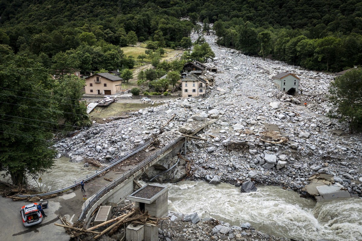 Rescue workers search the debris with a dog at the site of a landslide, caused by severe weather and heavy rain in the Misox valley, in Sorte village, Lostallo, southern Switzerland on Sunday June 23, ...