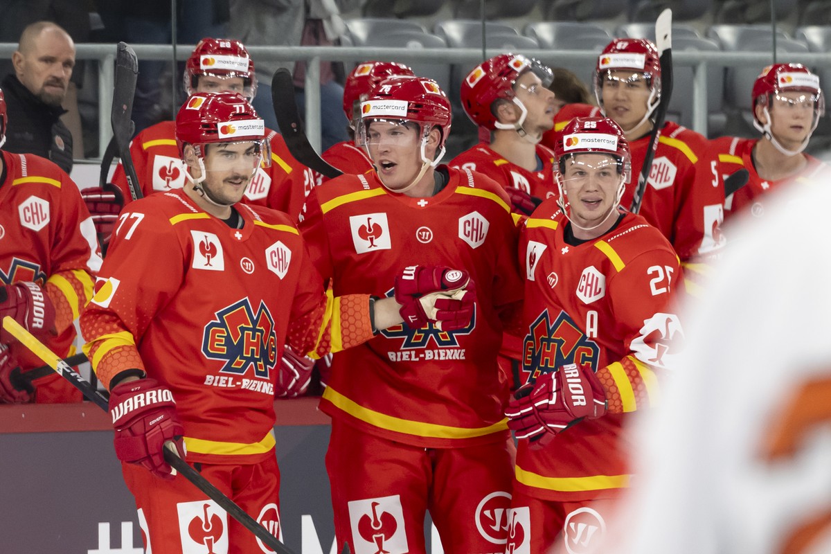 Biel?s Jere Sallinen, center, celebrates after scoring a goal 3-1 with Biel?s Robin Grossmann, left, and Biel?s Toni Rajala, right, during the Champions Hockey League match between Switzerland's  ...
