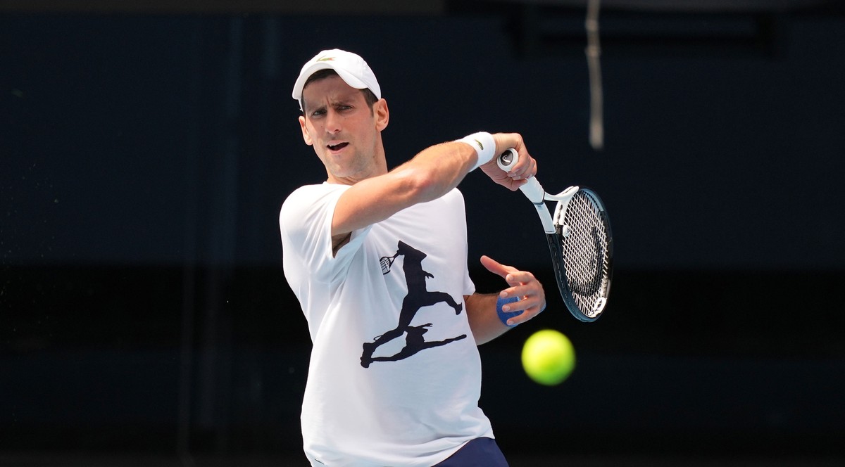 epa09678310 A handout photo made available by Tennis Australia of Novak Djokovic of Serbia during a practice session ahead of the Australian Open, Melbourne Park, in Melbourne, Australia 11 January 20 ...