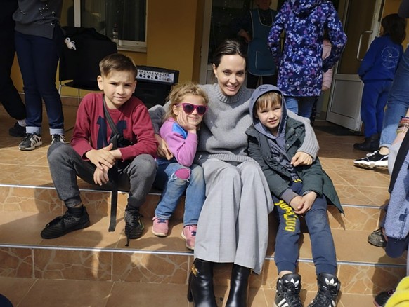 In this image provided by the Lviv city hall Angelina Jolie, Hollywood movie star and UNHCR goodwill ambassador, poses for photo with kids in Lviv, Ukraine, Saturday, Apr. 30, 2022. Ms Jolie was in Uk ...