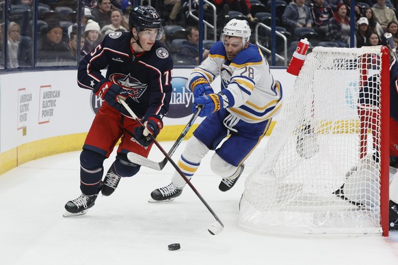 Columbus Blue Jackets&#039; Tim Berni, left, is defended by Buffalo Sabres&#039; Zemgus Girgensons during the third period of an NHL hockey game on Wednesday, Dec. 7, 2022, in Columbus, Ohio. (AP Phot ...