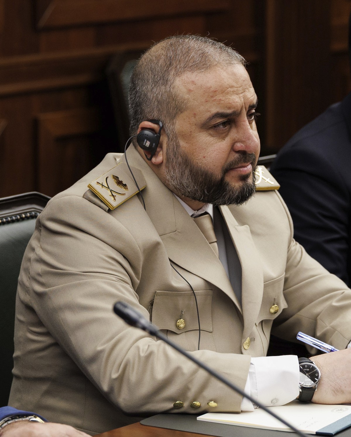 In this photo released by Russian Defense Ministry Press Service, Syrian Defense Minister Murhaf Abu Qasra, center, and Syrian Foreign Minister Asaad al-Shibani, right, attend a meeting with Russian D ...