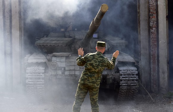 epa04961686 A pro-Russian separatist tank is seen in hangar during, as pro-Russian separatists said, withdrawing their heavy weapons from the front line, in Aleksandrovsk town, near Luhansk, Ukraine,  ...