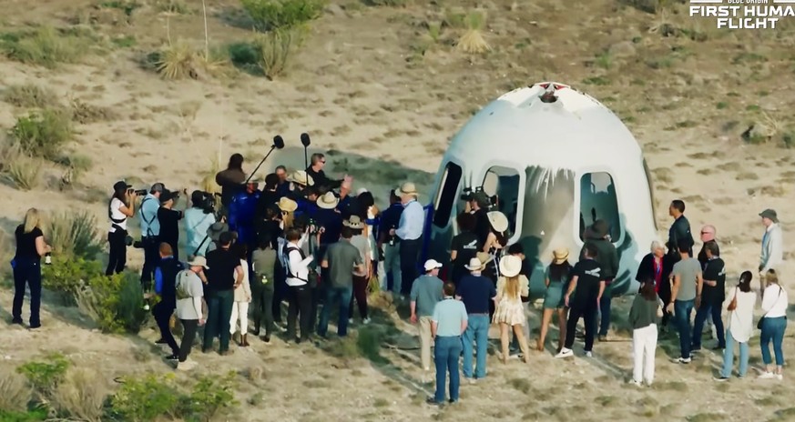 epa09355066 A frame grab from a Blue Origin handout video showing the scene around the landed capsule after Blue Origin New Shepard with Jeff Bezos, Mark Bezos, Wally Funk and Oliver Daemen returns to ...