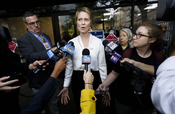 epa07017627 Democratic gubernatorial candidate Cynthia Nixon (C) talks to reporters after voting in New York, New York, USA, 13 September 2018. Nixon is challenging incumbent New York Governor Andrew  ...