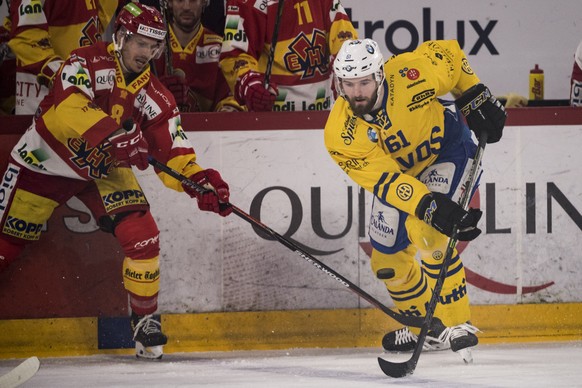 Biels Fabian Luethi, links, kaempft um den Puck gegen Davoser Fabian Heldner im dritten Eishockey Playoff-Viertelfinalspiel der National League zwischen dem HC Biel und dem HC Davos, am Donnerstag, 15 ...