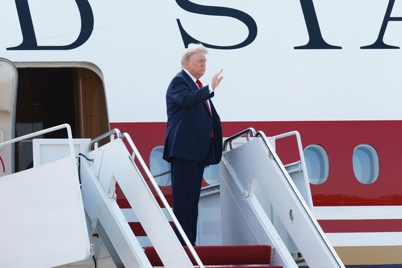 President Donald Trump waves as he boards the newly-designated Air Force One, a formerly Qatari-owned jumbo jet that has been converted into the official U.S. presidential aircraft, at Joint Base Andr ...