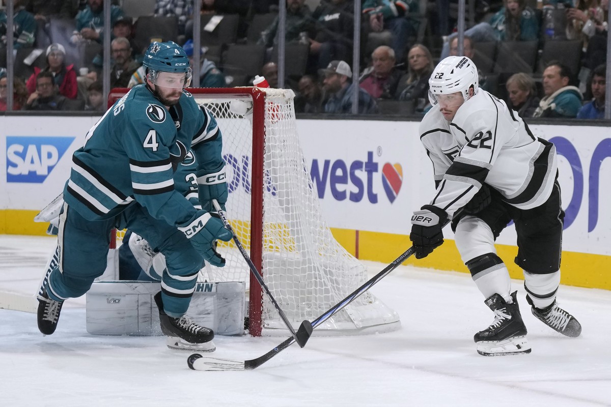 Los Angeles Kings left wing Kevin Fiala, right, shoots against San Jose Sharks defenseman Kyle Burroughs (4) during the second period of an NHL hockey game in San Jose, Calif., Tuesday, Dec. 19, 2023. ...