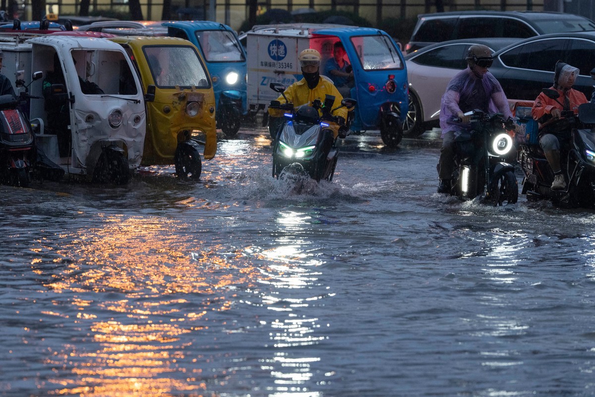 Motorists try to get through a flooded junction in Beijing, Friday, July 10, 2026. (AP Photo/Ng Han Guan)
China Asia Storms