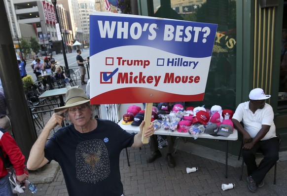 A protestor holds a sign near the venue hosting the Republican National Convention in Cleveland, Ohio, U.S., July 18, 2016. REUTERS/Aaron Josefczyk