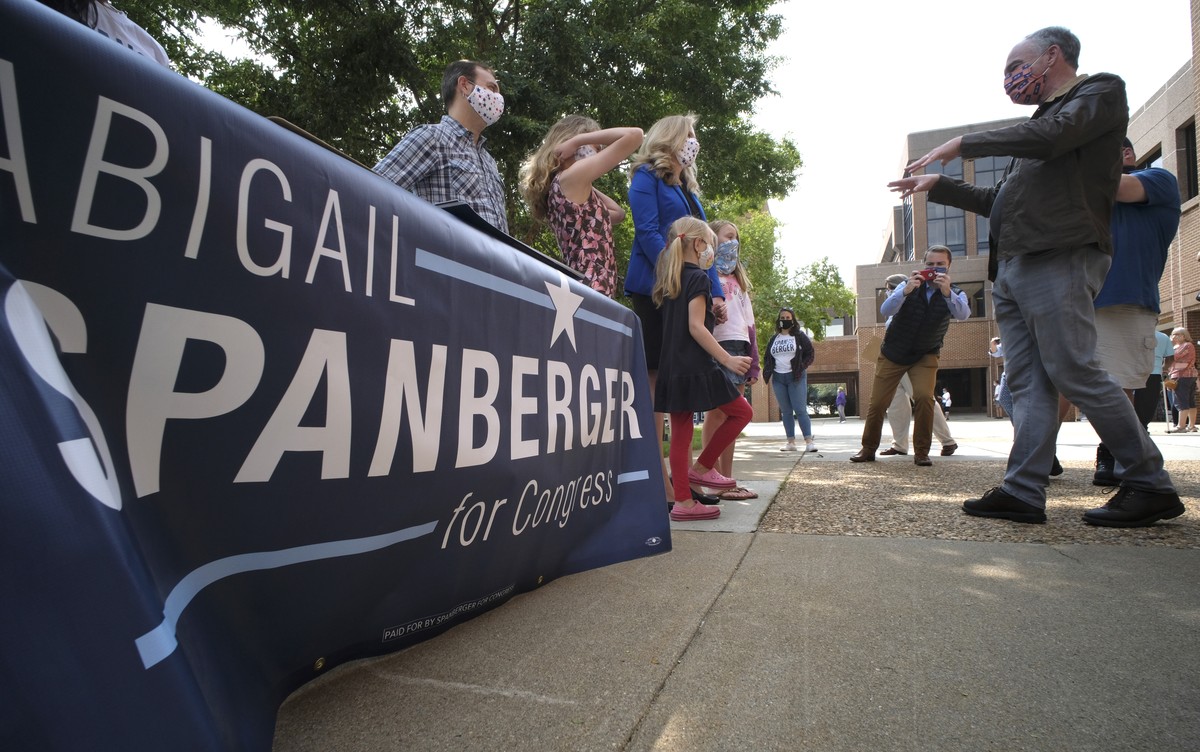 Sen. Tim Kaine, D-Va., right, talks with U.S. Rep. Abigail Spanberger, D-Va., and family as they arrived to vote at the Henrico County general registrar's office in Henrico County, Va., Friday, S ...