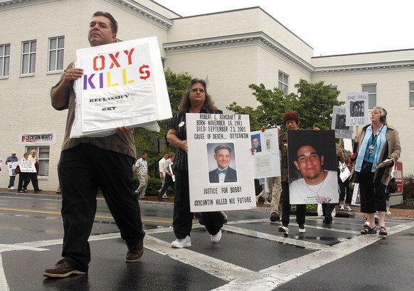 FILE - In this Friday, July 20, 2007 file photo, demonstrators march along Main Street in Abingdon, Va., to raise awareness about the abuse of OxyContin. From 2000 to 2016, prescription opioid abuse h ...