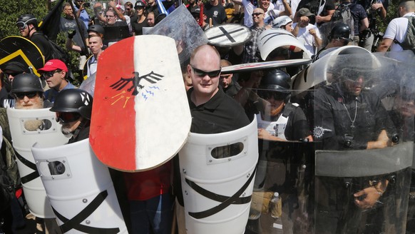FILE - In this Aug. 12, 2017 file photo, white nationalist demonstrators use shields as they guard the entrance to Lee Park in Charlottesville, Va. The American Civil Liberties Union is reeling from c ...