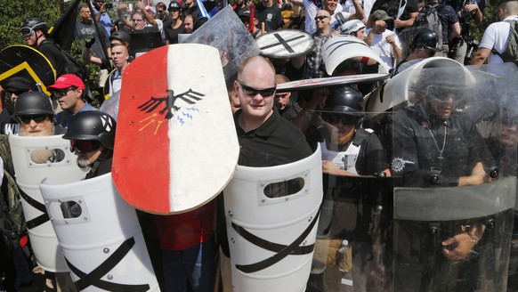 FILE - In this Aug. 12, 2017 file photo, white nationalist demonstrators use shields as they guard the entrance to Lee Park in Charlottesville, Va. The American Civil Liberties Union is reeling from c ...