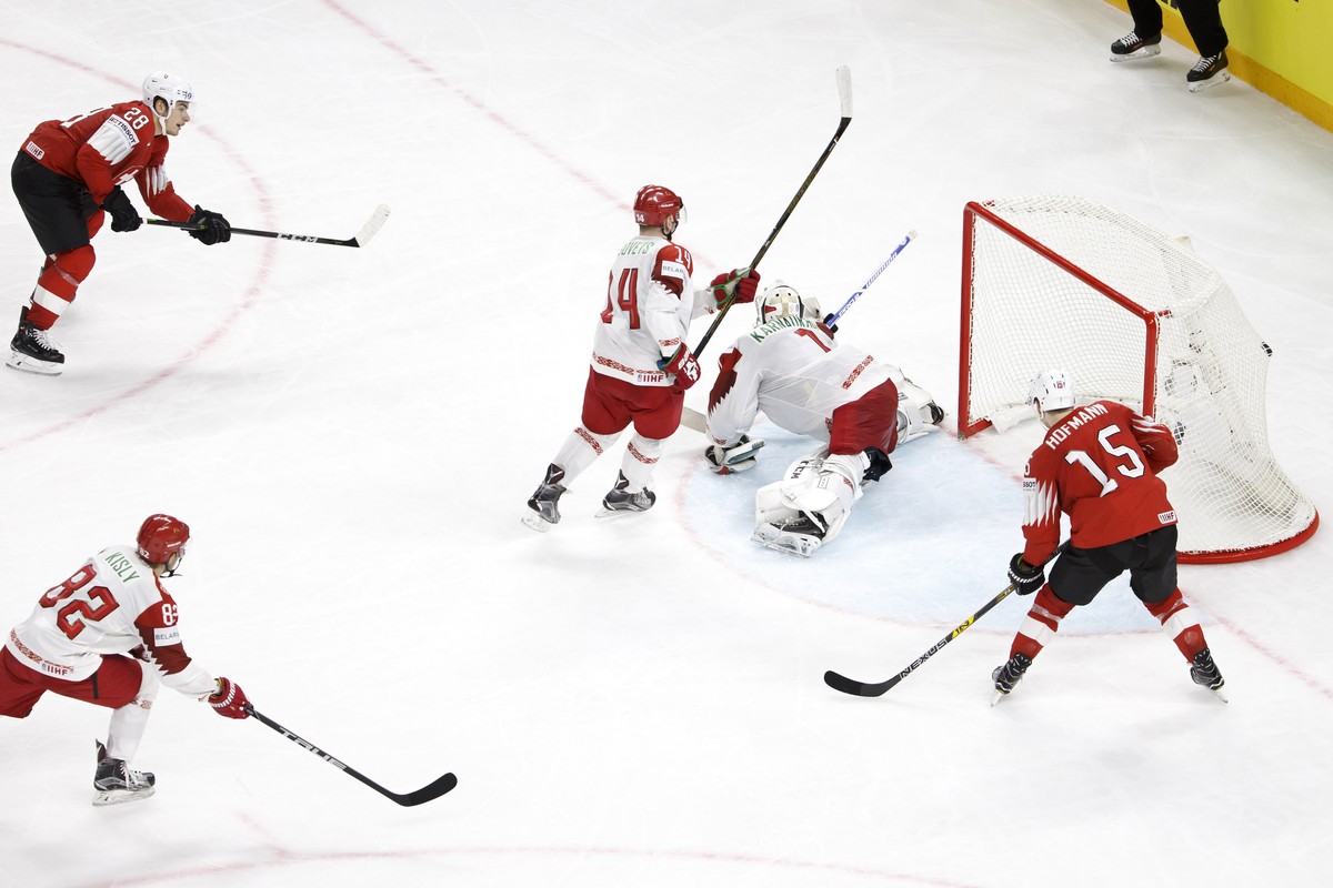 Switzerland's forward Timo Meier #28 scores the 5:2 against Belarus' goaltender Mikhail Karnaukhov, 2nd right, past Belarus' forward Artyom Kisly #82, defender Yevgeni Lisovets #14 and  ...