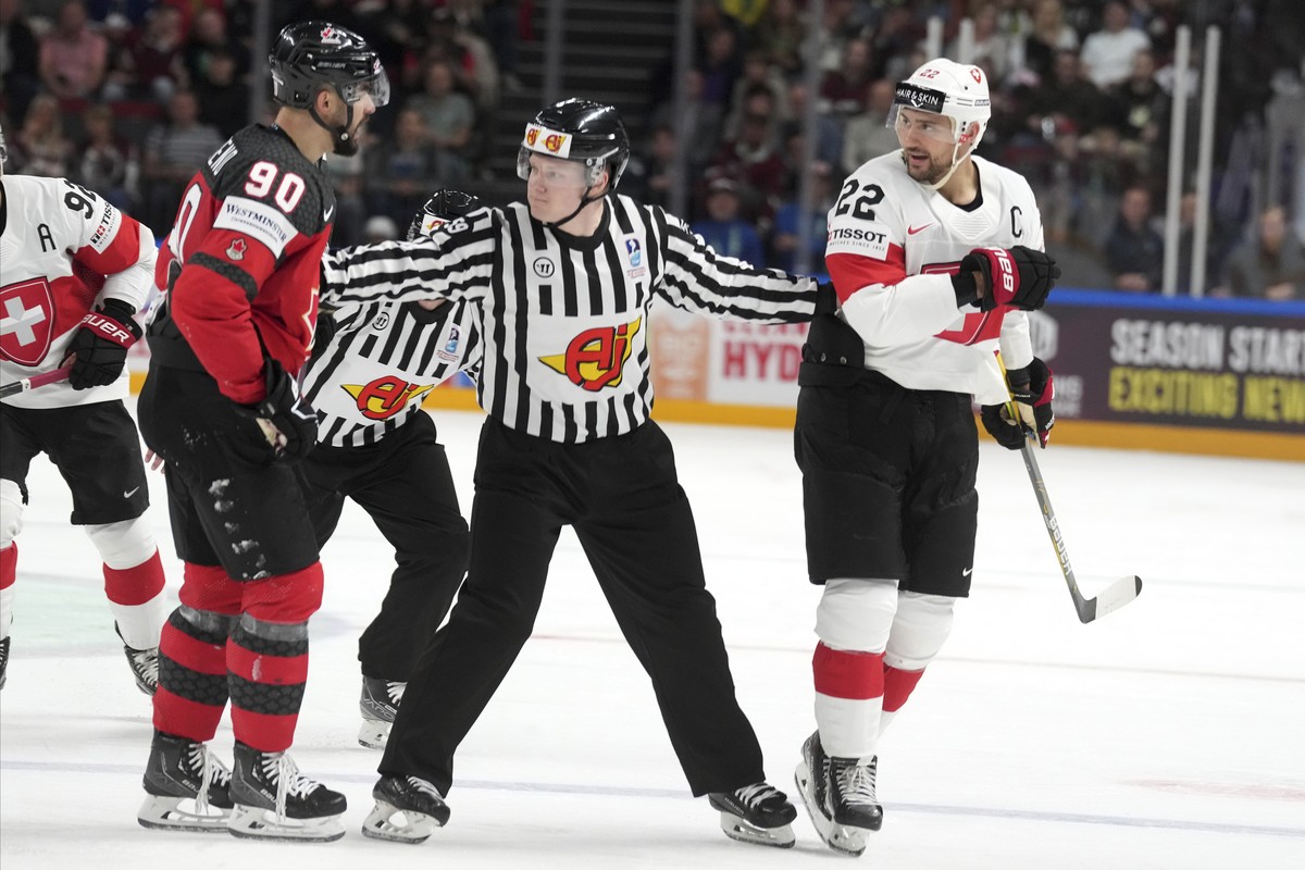 Nino Niederreiter of Switzerland, right, talks to Joseph Veleno of Canada during the group B match between Switzerland and Canada at the ice hockey world championship in Riga, Latvia, Saturday, May 20 ...