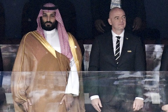 FILE - Saudi Arabia Crown Prince Mohammed bin Salman, left, and FIFA President Gianni Infantino, stand for the anthem prior to opening soccer match of the 2018 World Cup between Russia and Saudi Arabi ...