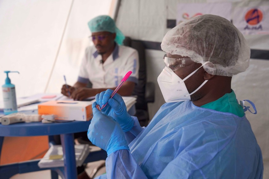 Doctors label a sample collected from a participant during clinical trials attempting to stop the rare Bundibugyo virus, amidst a deadly Ebola outbreak, in Rwampara Hospital in Ituri, Congo, Thursday, ...