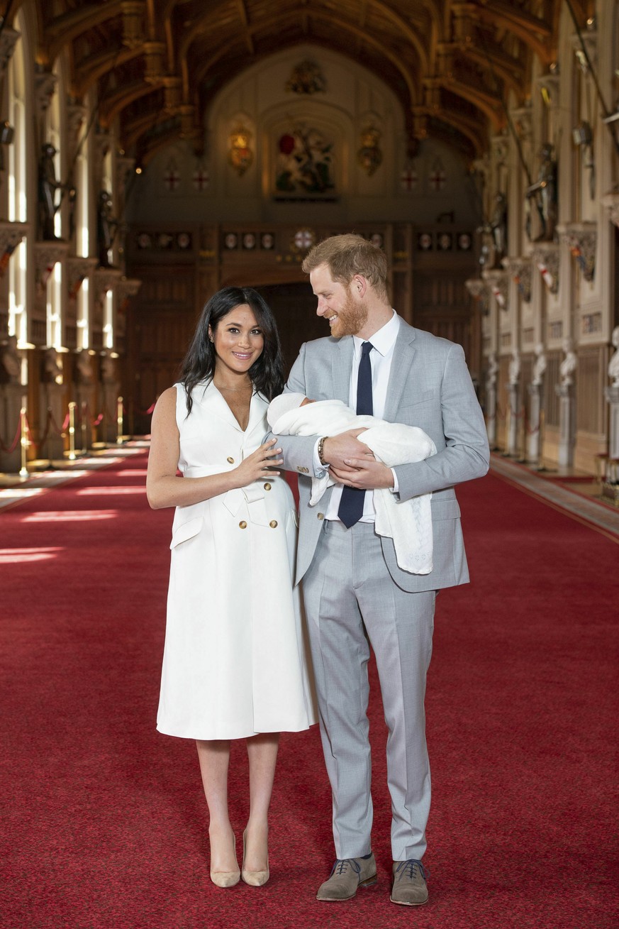 Britain&#039;s Prince Harry and Meghan, Duchess of Sussex, during a photocall with their newborn son, in St George&#039;s Hall at Windsor Castle, Windsor, south England, Wednesday May 8, 2019. Baby Su ...