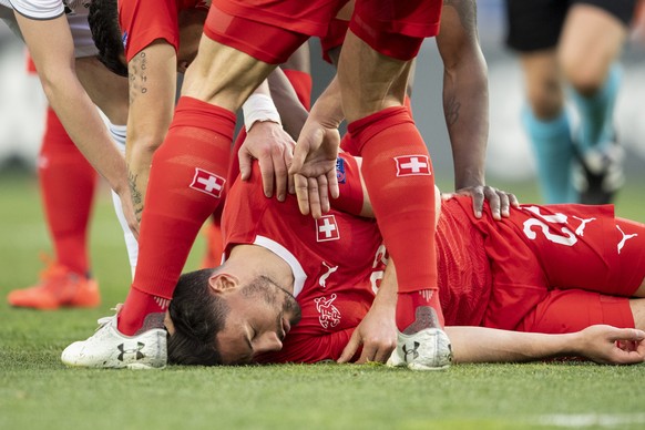 epa07458445 Switzerland&#039;s Fabian Schaer (C) lies down on the ground during the UEFA Euro 2020 qualifier Group D soccer match between Georgia and Switzerland at the Boris Paichadze National Stadiu ...