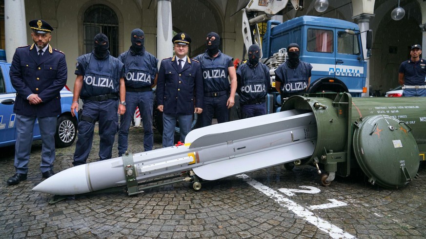Police stand by a missile seized at an airport hangar near Pavia, northern Italy, following an investigation into Italians who took part in the Russian-backed insurgency in eastern Ukraine, in Turin,  ...