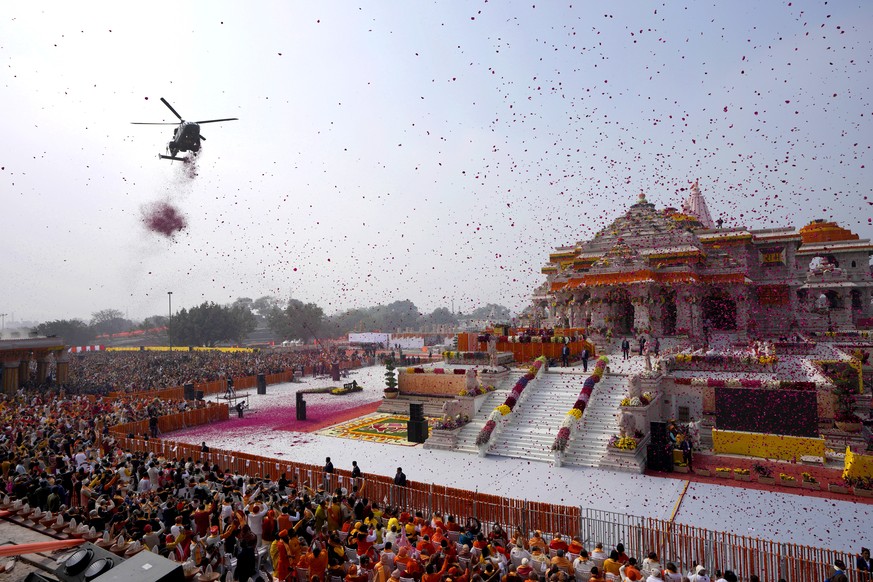 An Indian Air Force helicopter showers flower petals during the opening of a temple dedicated to Hinduism&#039;s Lord Ram in Ayodhya, India, Monday, Jan. 22, 2024. Indian Prime Minister Narendra Modi  ...