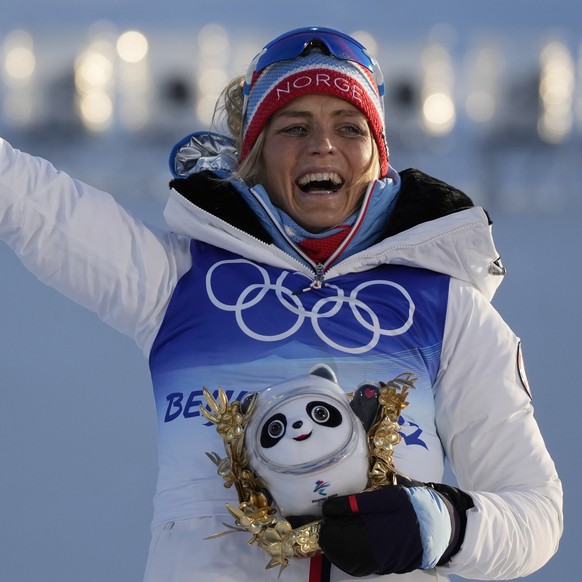 Gold medal finisher Norway&#039;s Therese Johaug reacts after the women&#039;s 7.5km + 7.5km skiathlon cross-country skiing competition at the 2022 Winter Olympics, Saturday, Feb. 5, 2022, in Zhangjia ...