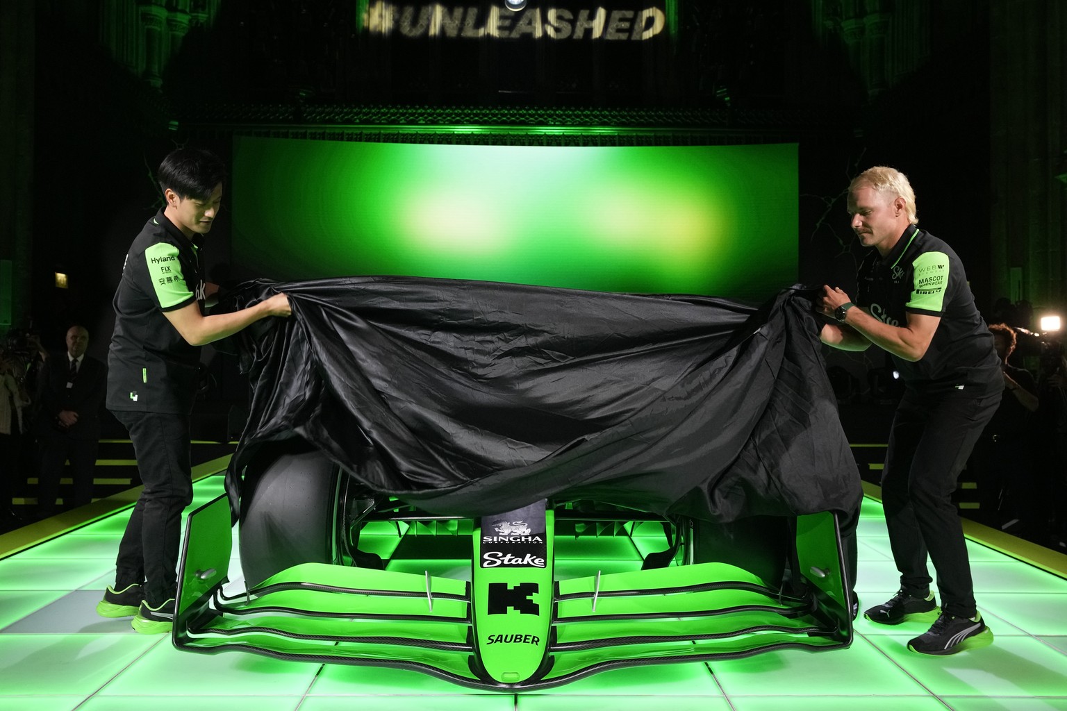Stake F1 Team Kick Sauber&#039;s Zhou Guanyu, left and teammate Valtteri Bottas unveil the Formula One auto racing 2024 Kick Sauber C44 car during its launch in London Monday, Feb. 5, 2024. (AP Photo/ ...