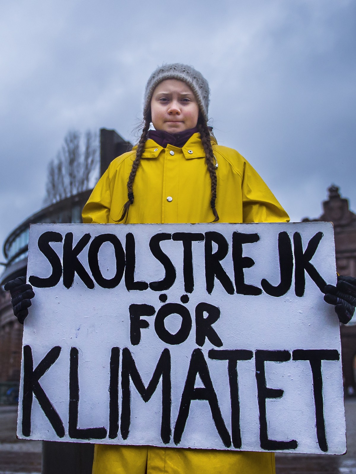 epa07199174 Swedish 15-year-old girl Greta Thunberg holds a placard reading 'School strike for the climate', during a protest against climate change outside the Swedish parliament in Stockho ...