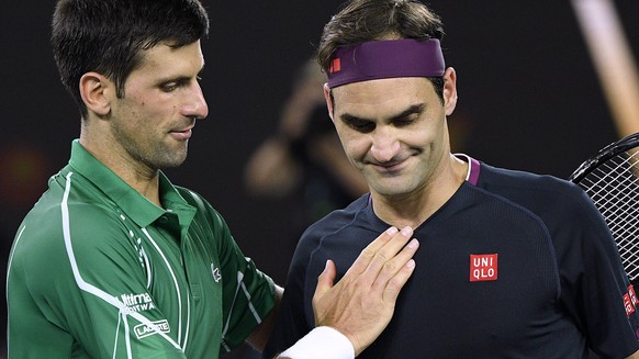 Switzerland&#039;s Roger Federer, right, congratulates Serbia&#039;s Novak Djokovic on winning their semifinal match at the Australian Open tennis championship in Melbourne, Australia, Thursday, Jan.  ...