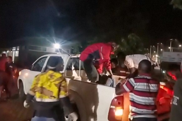 This grab from video provided by Ugandan Red Cross shows injured children being brought in a pickup vehicle to a hospital after an elementary bus crashed Thursday night in the Kapchorwa District in ea ...