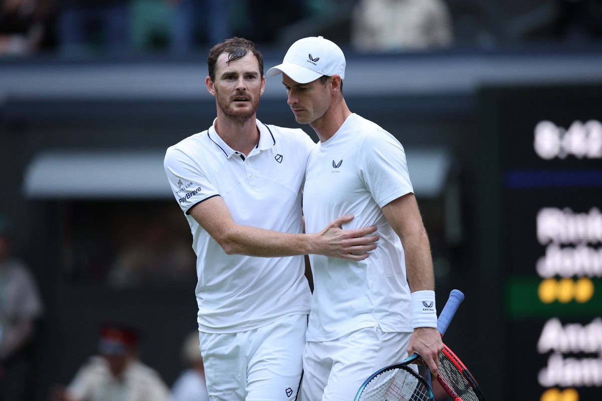 epa11457924 Andy Murray (R) and Jamie Murray (L) of Britain embrace after losing against John Peers and Rinky Hijikata of Australia (both unseen) during their Men's doubles 1st round match at the ...