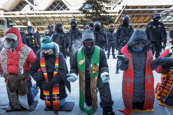 Clergy members and community activists gather at the Minneapolis-St. Paul International Airport, to protest deportation flights and urge airlines to call for an end to the Department of Homeland Secur ...
