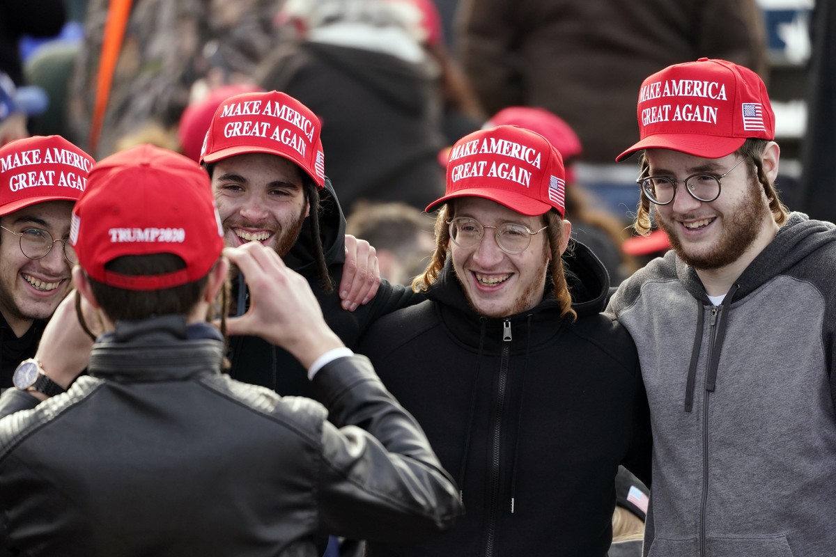 Supporters pose for a photo before President Donald Trump speaks during a campaign rally at Manchester-Boston Regional Airport, Sunday, Oct. 25, 2020, in Londonderry, N.H. (AP Photo/Elise Amendola)