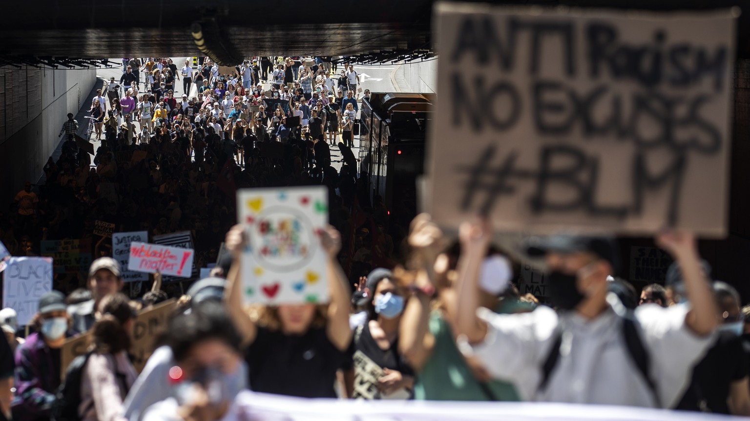 People demonstrate at a &quot;Black Lives Matter&quot; rally to mark the death of George Floyd in Zurich, Switzerland, Monday, 1 June 2020. Floyd died after being restrained by Minneapolis police offi ...