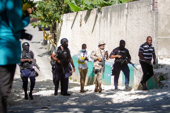 epa09330640 Police agents work near the house of the assassinated Haitian president, Jovenel Moise, in Port-au-Prince, Haiti, 07 July 2021. Four alleged assassins of the Haitian President Jovenel Mois ...