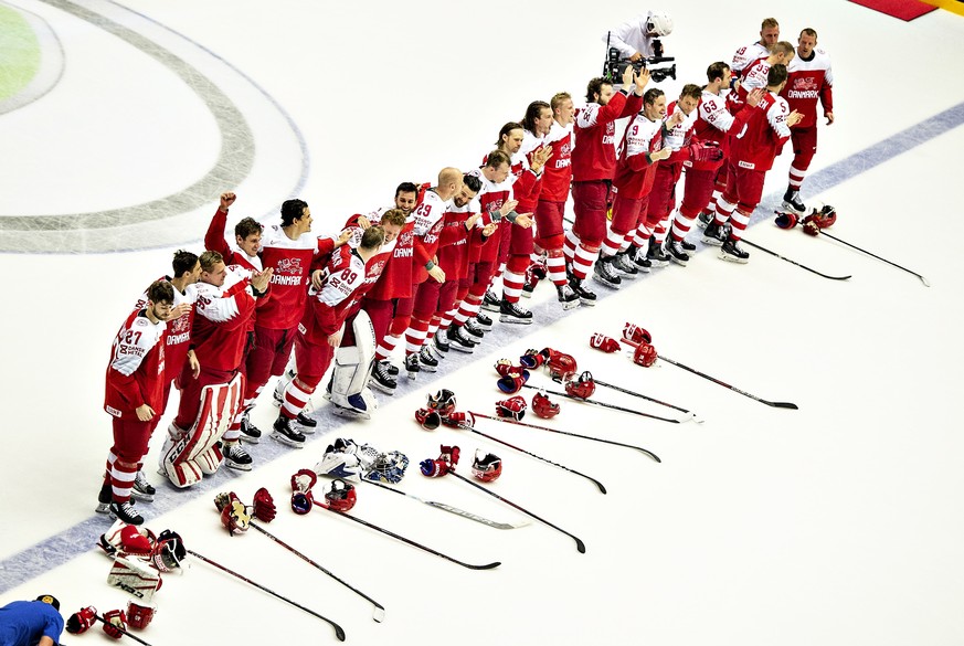 epa06728377 Players of Denmark celebrate after winning the IIHF World Championship Group B ice hockey match between Denmark and Norway at Jyske Bank Boxen arena in Herning, Denmark, 11 May 2018. EPA/H ...