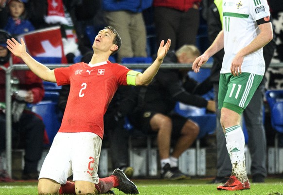 Switzerland&#039;s defender Stephan Lichtsteiner, left, past Northern Ireland&#039;s midfielder Chris Brunt, right, celebrate their qualifying for the 2018 FIFA World Cup Russia after beating Northern ...