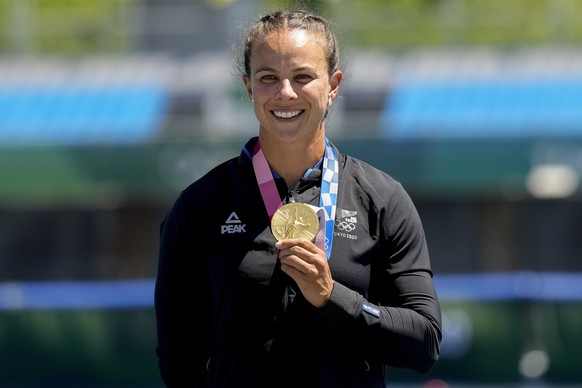 Lisa Carrington, of Team New Zealand, holds up her gold medal after winning the women's kayak single 500m final at the 2020 Summer Olympics, Thursday, Aug. 5, 2021, in Tokyo, Japan. (AP Photo/Lee Jin- ...