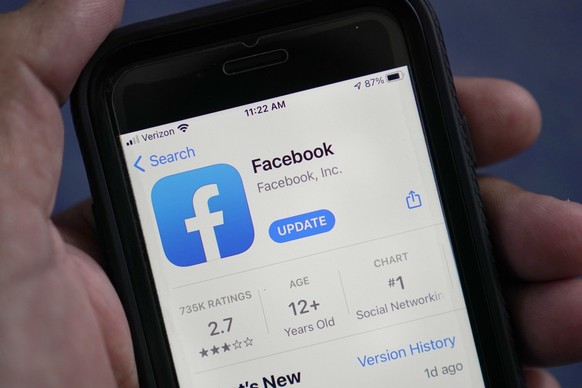 FILE - The Facebook app is shown in the app store on a smart phone in Surfside, Fla., on April 23, 2021. According to a new report from the nonprofit groups Global Witness and Foxglove, Facebook is le ...