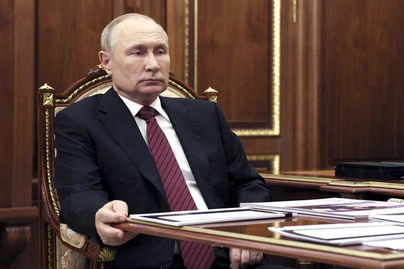 Russian President Vladimir Putin listens to Russian Culture Minister Olga Lyubimova during their meeting in Moscow, Russia, Monday, Oct. 3, 2022. (Gavriil Grigorov, Sputnik, Kremlin/Pool Photo via AP)