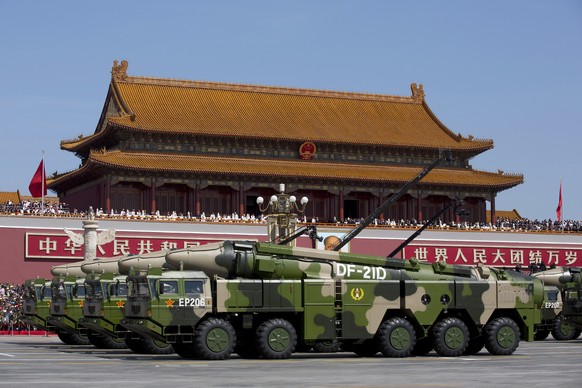 FILE - Chinese military vehicles carrying DF-21D anti-ship ballistic missiles, potentially capable of sinking a U.S. Nimitz-class aircraft carrier in a single strike, drive past Tiananmen Gate during  ...