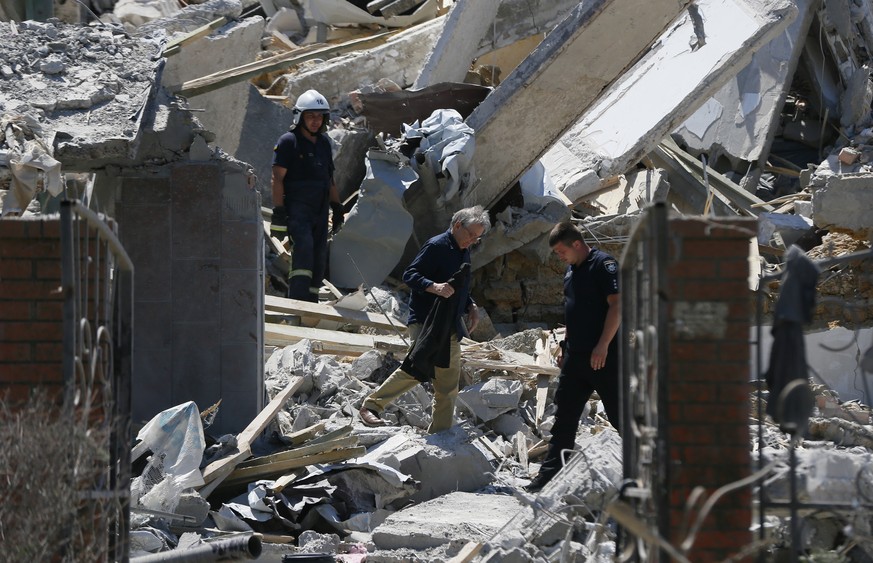 epa10046645 Rescuers and policemen work at the scene of a destroyed holiday hotel after shelling hit the small town of Serhiivka near Odesa, southern Ukraine, 01 July 2022. At least 19 people were kil ...