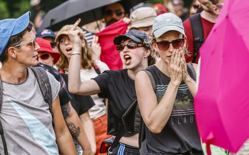 epa10748229 People protest in front of the Olympia stadium ahead of a scheduled concert by German rock band Rammstein in Berlin, Germany, July 15, 2023. Protesters are calling for the cancellation of ...