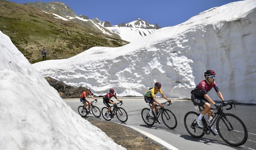 Leader Egan Bernal from Colombia, 2nd right, is sourrounded by two Ineos team mates and followed by Australias Rohan Dennis, left, team Bahrain-Merida, at the Nufenen pass during the ninth and final s ...