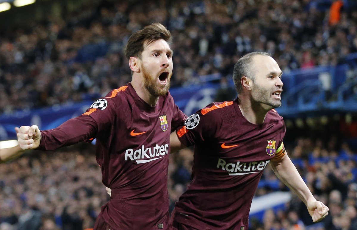 Barcelona's Lionel Messi celebrates with Andres Iniesta scoring his side's first goal during a Champions League round of sixteen first leg soccer match between FC Barcelona and Chelsea at St ...