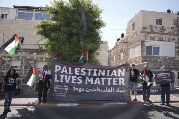 Protesters hold posters for slain Palestinian-American journalist Shireen Abu Akleh near the Augusta Victoria Hospital in east Jerusalem ahead of a visit by U.S. President Joe Biden, Friday, July 15,  ...