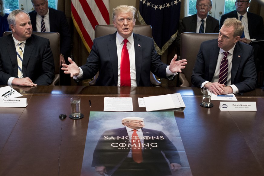 epa07258737 US President Donald J. Trump (C) speaks in front of a poster depicting his image, beside US Acting Secretary of the Interior David Bernhardt (L) and Acting Secretary of Defense Patrick Sha ...