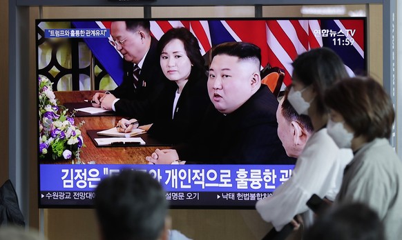 People watch a TV news program reporting about North Korea with file footage of North Korean leader Kim Jong Un, at the Seoul Railway Station in Seoul, South Korea, Saturday, April 13, 2019. North Kor ...