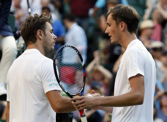 Russia&#039;s Daniil Medvedev, right, after winning his Men&#039;s Singles Match against Switzerland&#039;s Stan Wawrinka, on the opening day at the Wimbledon Tennis Championships in London Monday, Ju ...